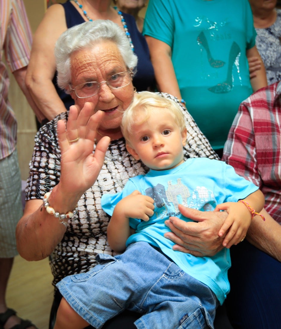 Una mujer y un niño saludan a la cámara.