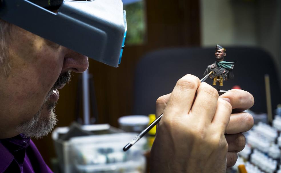 José Hernández pinta un busto, la miniatura de un soldado, en el taller donde imparte clase.