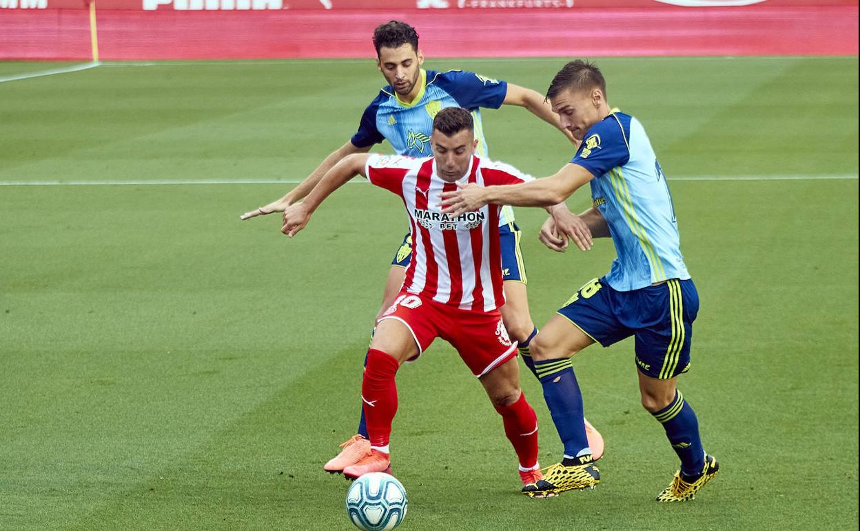 Iván Martos y Maras intentan frenar la progresión de Borja García. 