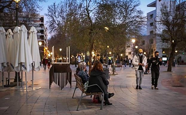 Las terrazas de Puerta Real aparecen recogidas mientras los granadinos estiran la tarde con sus paseos.