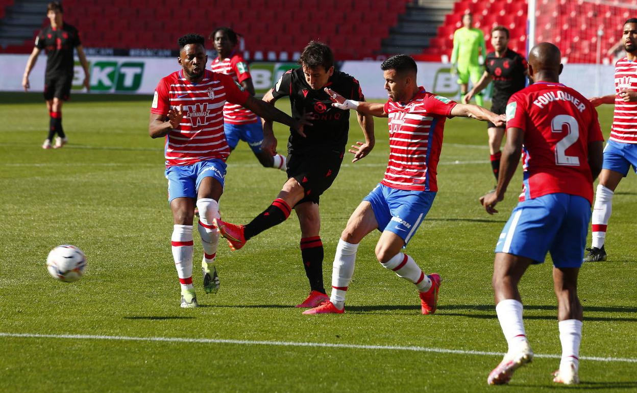 Oyarzabal chuta a puerta rodeado de futbolistas del Granada. 