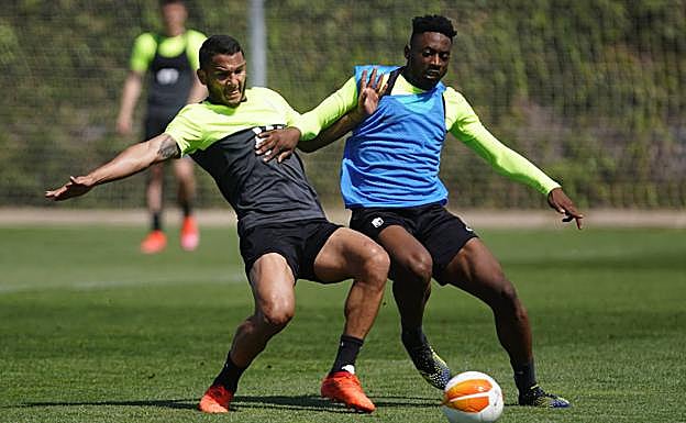 Luis Suárez pugna un balón con su compañero Eteki. 