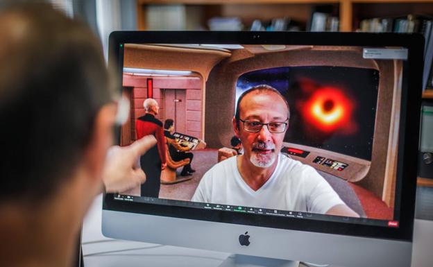 El investigador, conectado a una video conferencia, con su fondo de la Enterprise. 