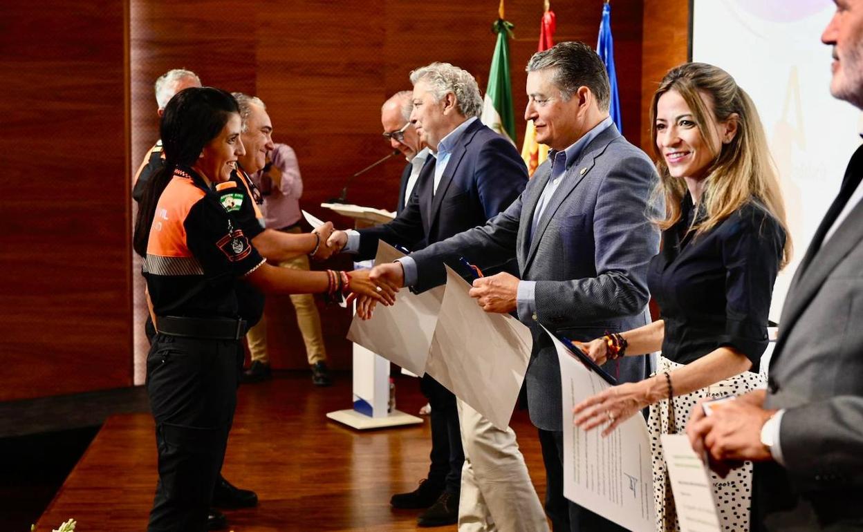 Antonio Sanz, junto a otras autoridades, entrega un reconocimiento a miembros de Protección Civil. 