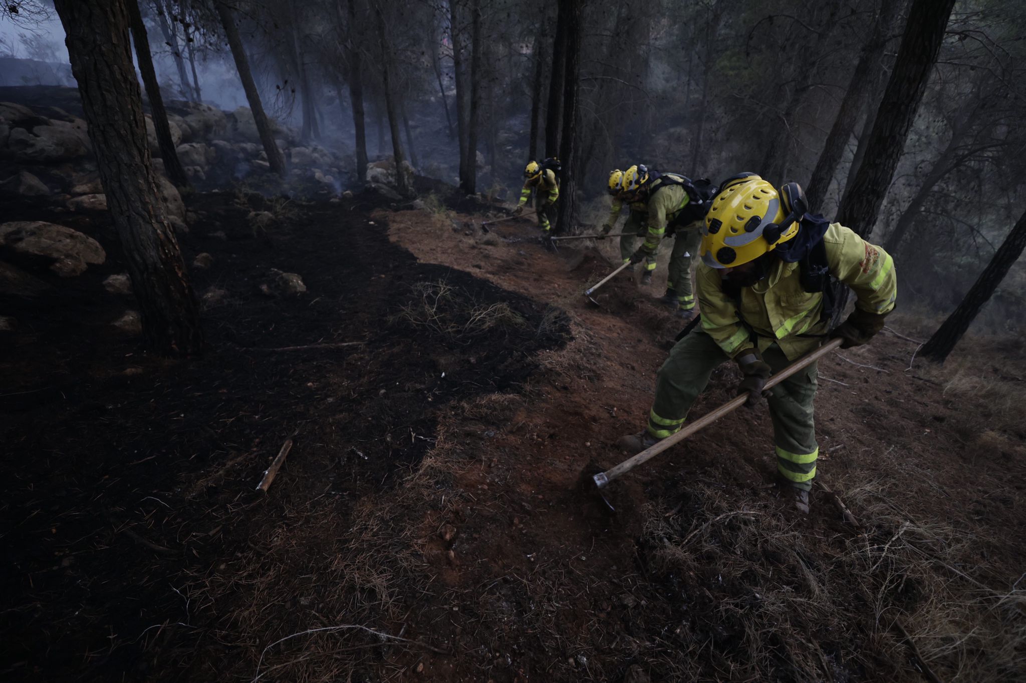 Bomberos terrestres y medios aéreos luchan contra el fuego.