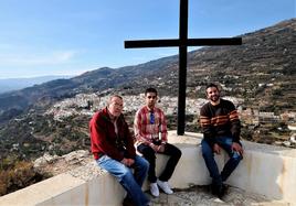 Tres vecinos junto a la cruz de la ermita.