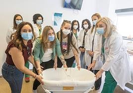 Madres y profesionales sanitarios del Clínico posan con la cuna fría.