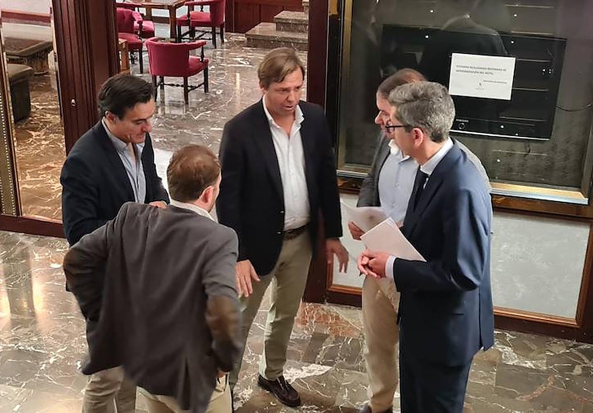 El secretario general del PP andaluz habla con los dirigentes de JM+ en presencia de Erik Domínguez y Agustín González, tras salir de la firma notarial y antes de anunciar el pacto de gobierno.