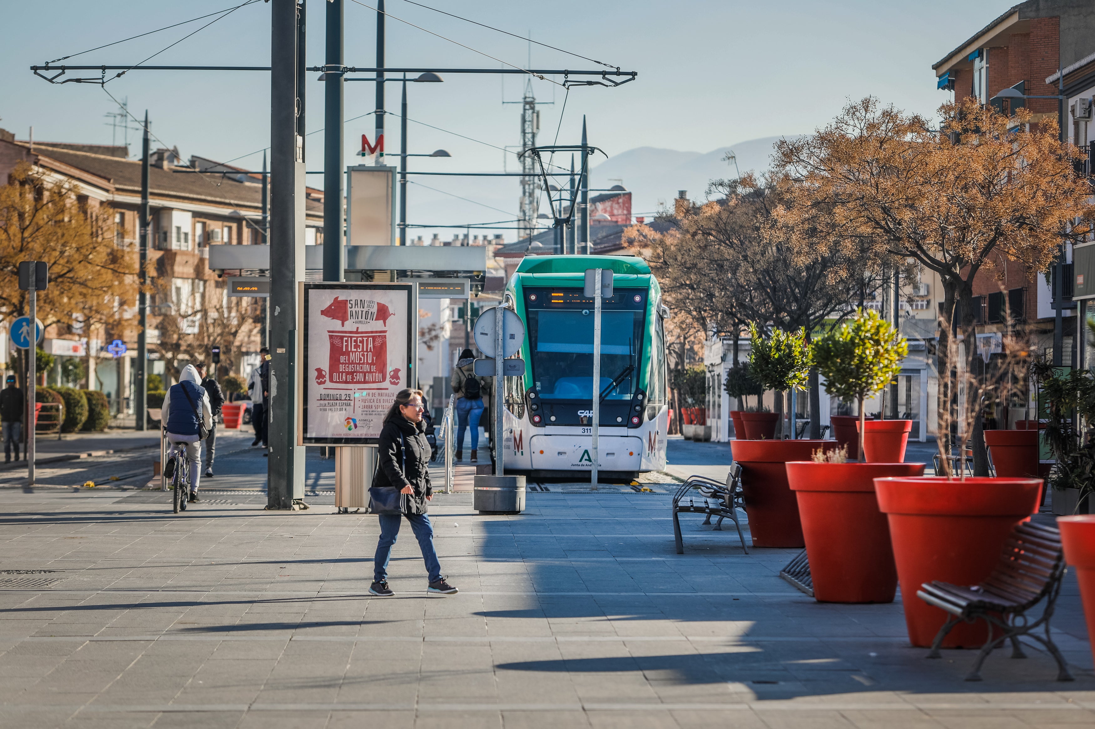 Una mujer pasea por delante de una parada de metro.