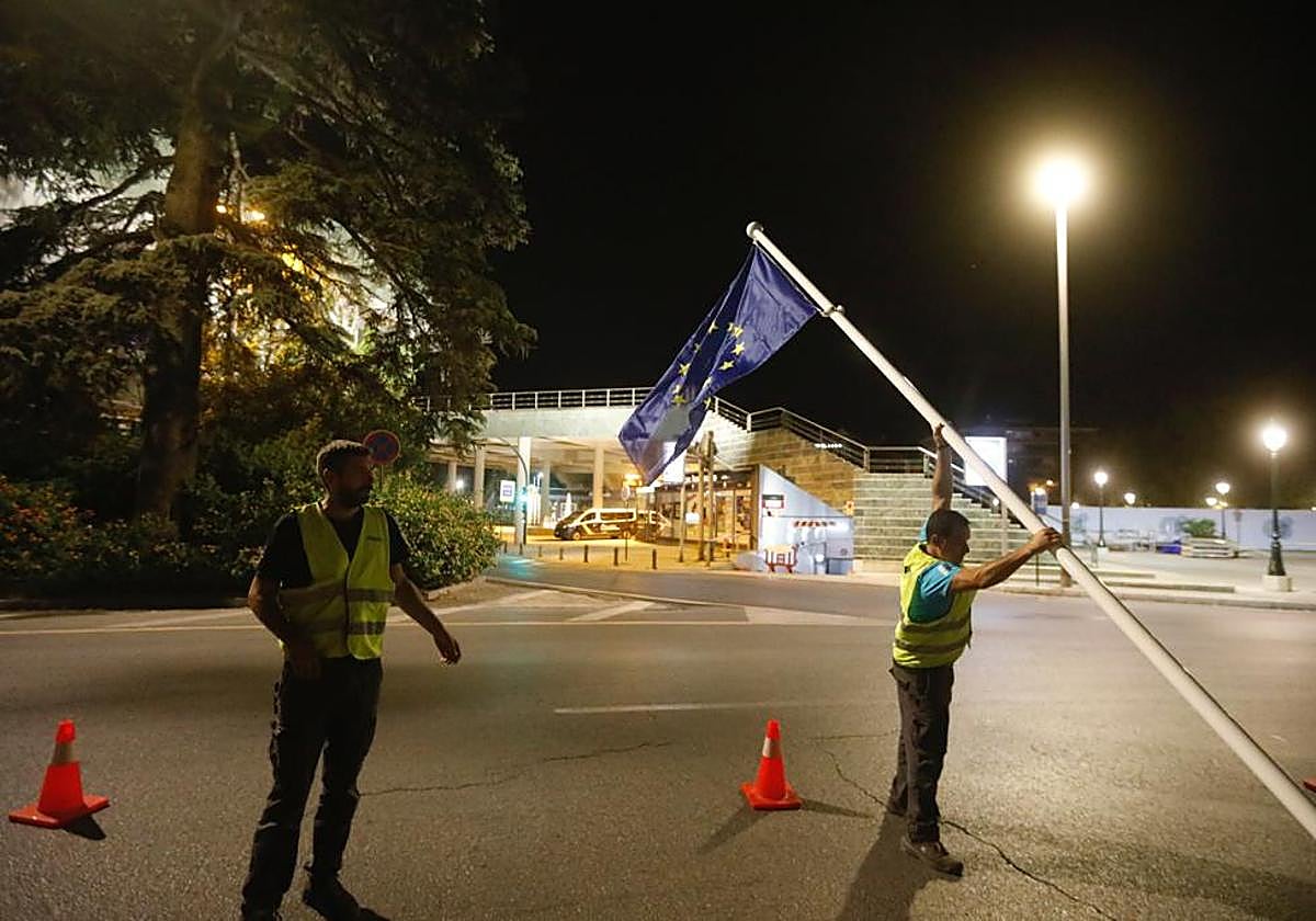 Operarios colocan una bandera de Europa junto al Palacio de Congresos.