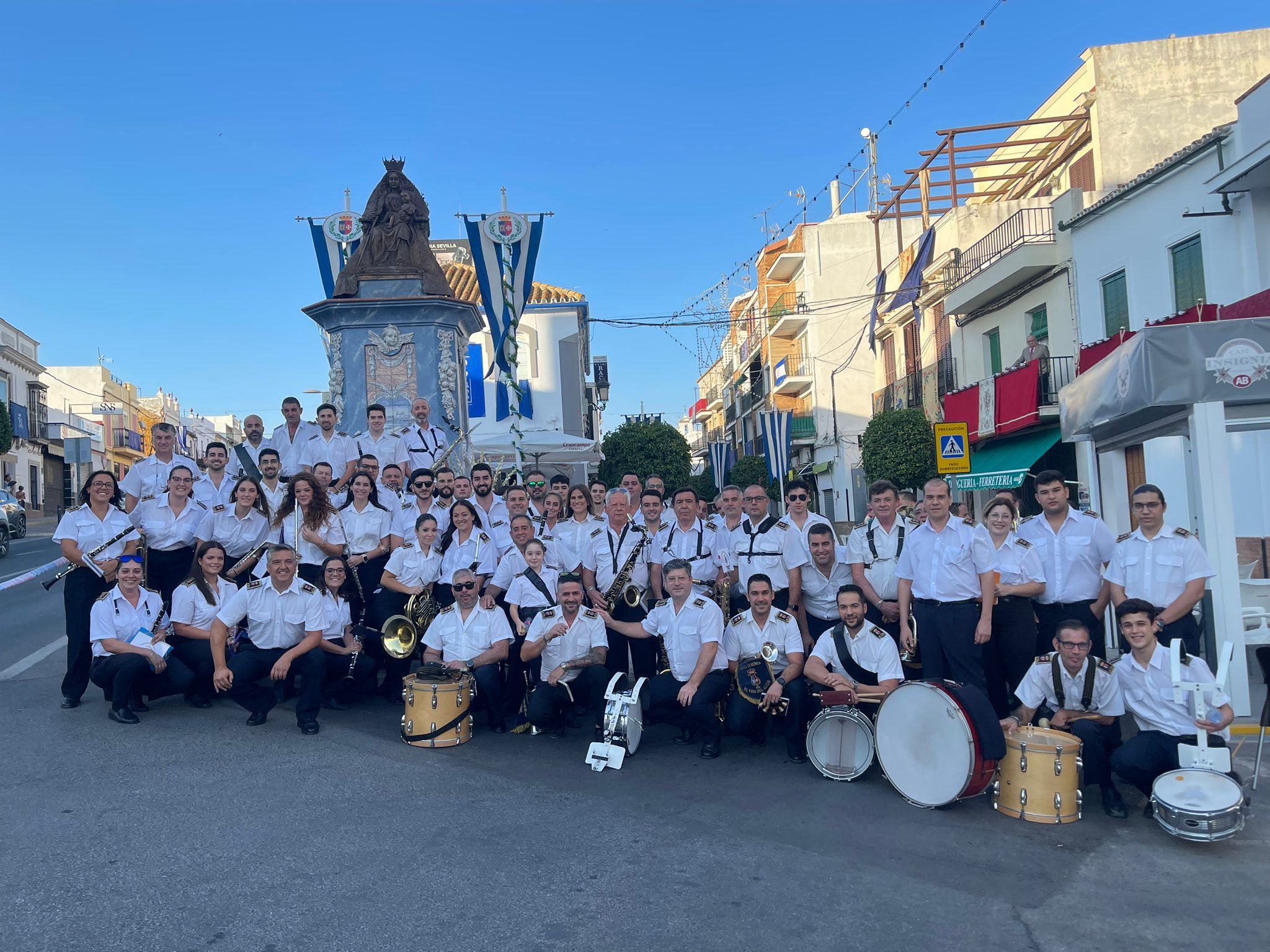 La banda Santa María del Alcor posa junto al Triunfo en honor a dicha imagen, en El Viso del Alcor.