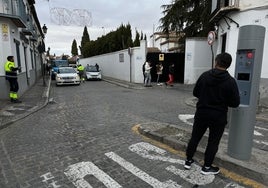 Un visitante deja su vehículo en doble fila mientras trata de que le abran la barrera.