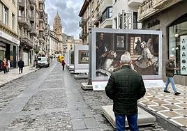 Un hombre observa una reproducción de Las Meninas, de Velázquez, en la Carrera.