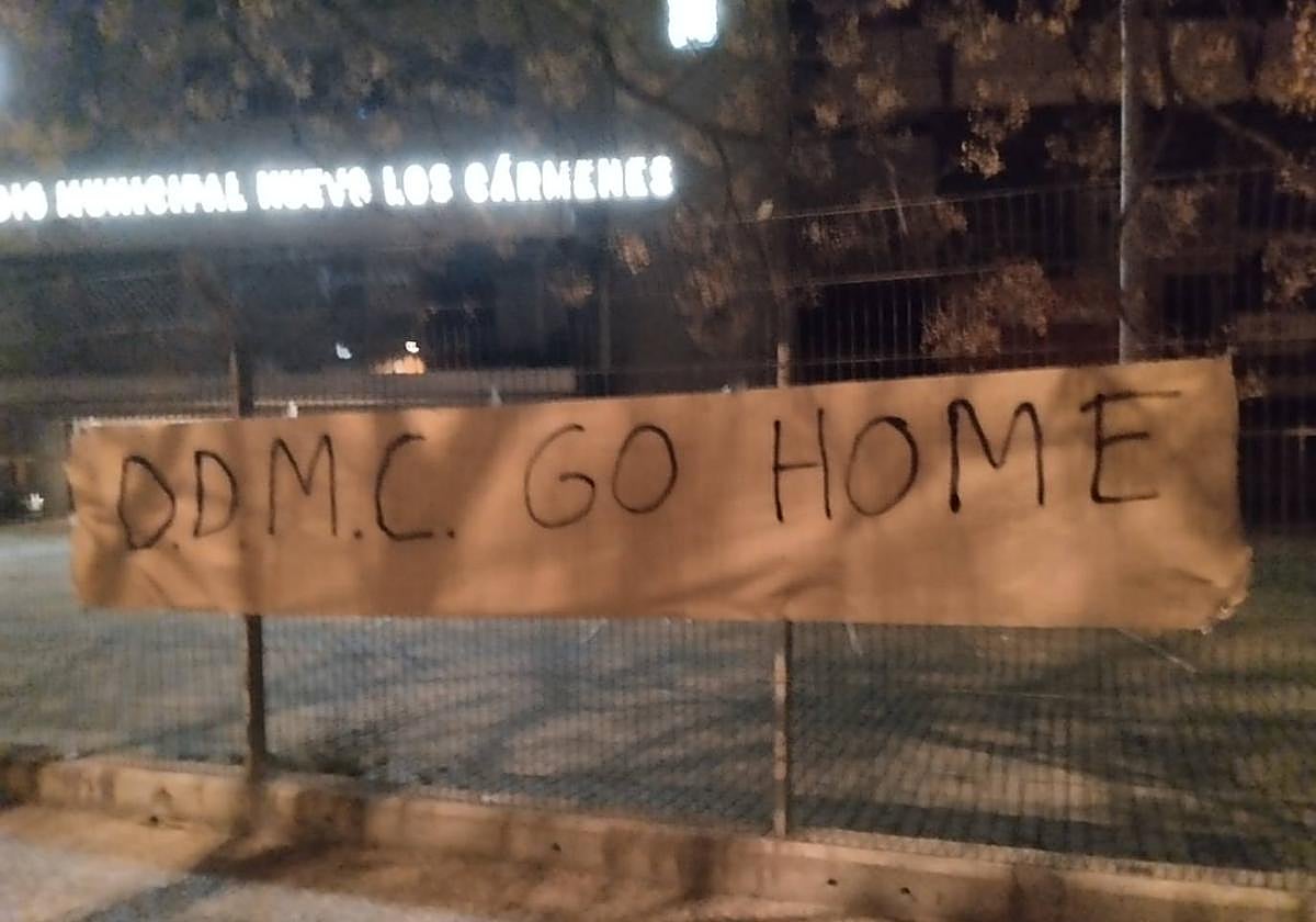 Una de las pancartas en la valla del aparcamiento del estadio.