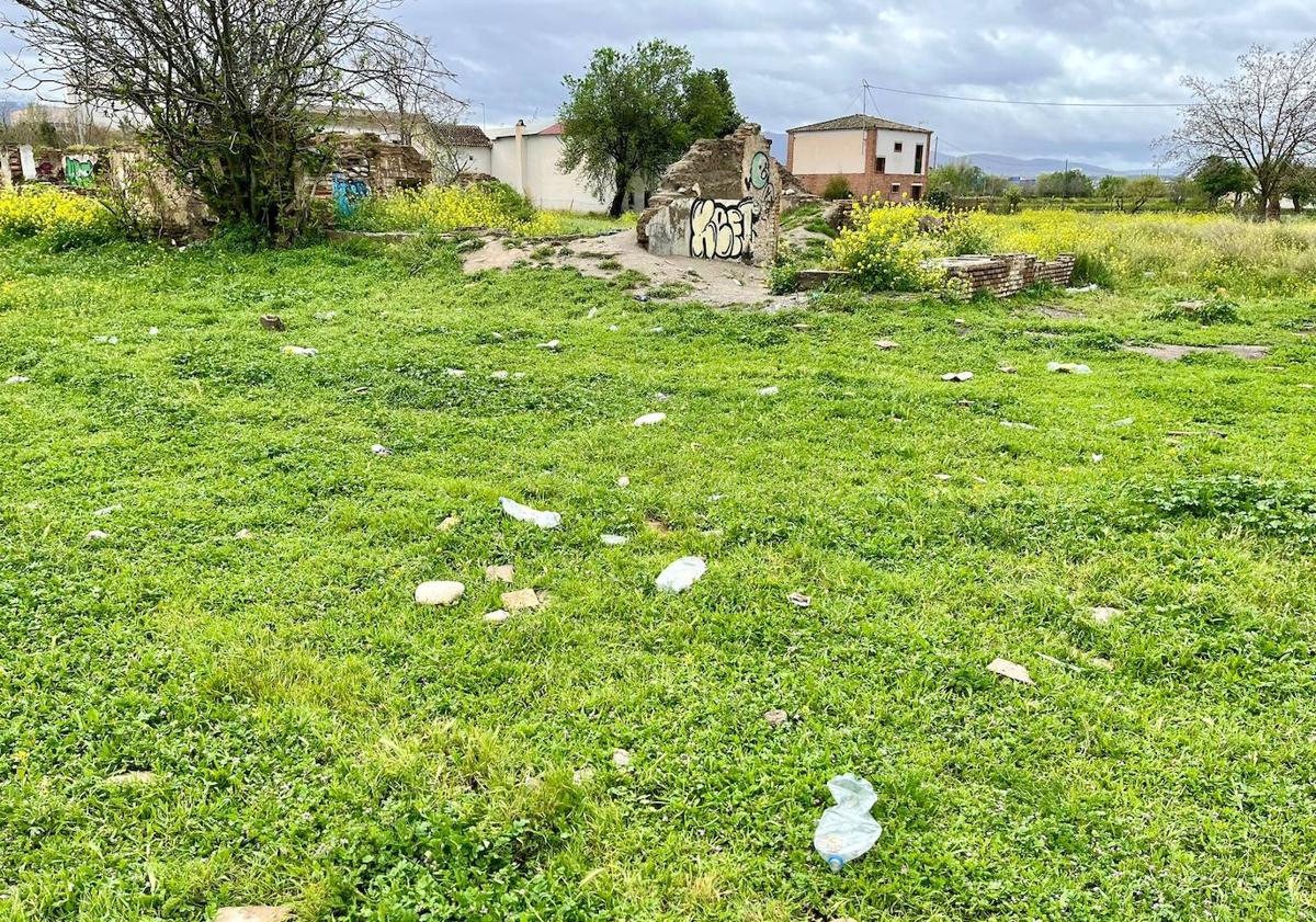 Imagen principal - El rastro de plásticos y botellas lleva a la casa en ruinas. 