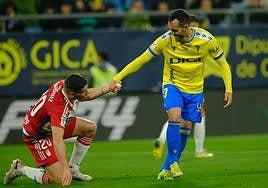 Juanmi levanta a Sergio Ruiz durante el partido.