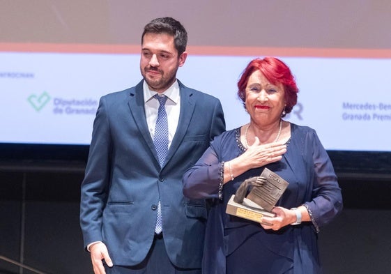 Marisol Casas, 'Cuca', recibe emocionada el premio de manos del jefe de Audiencias, Diego Callejón.