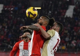 Luis Suárez se anticipa para controlar el balón ante Pablo Tomeo.