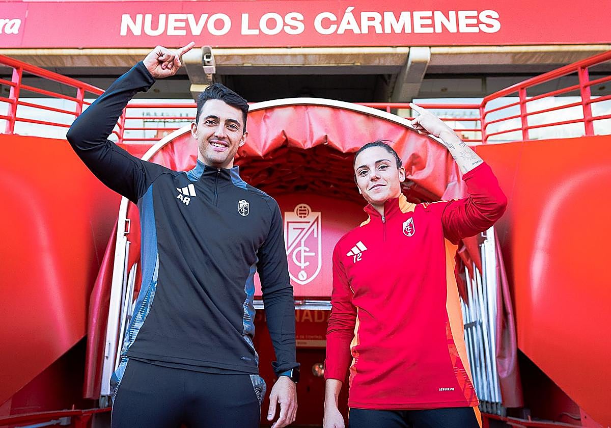 Arturo Ruiz y Alba Pérez señalan el cartel de Los Cármenes después del último entrenamiento del equipo previo al partido.