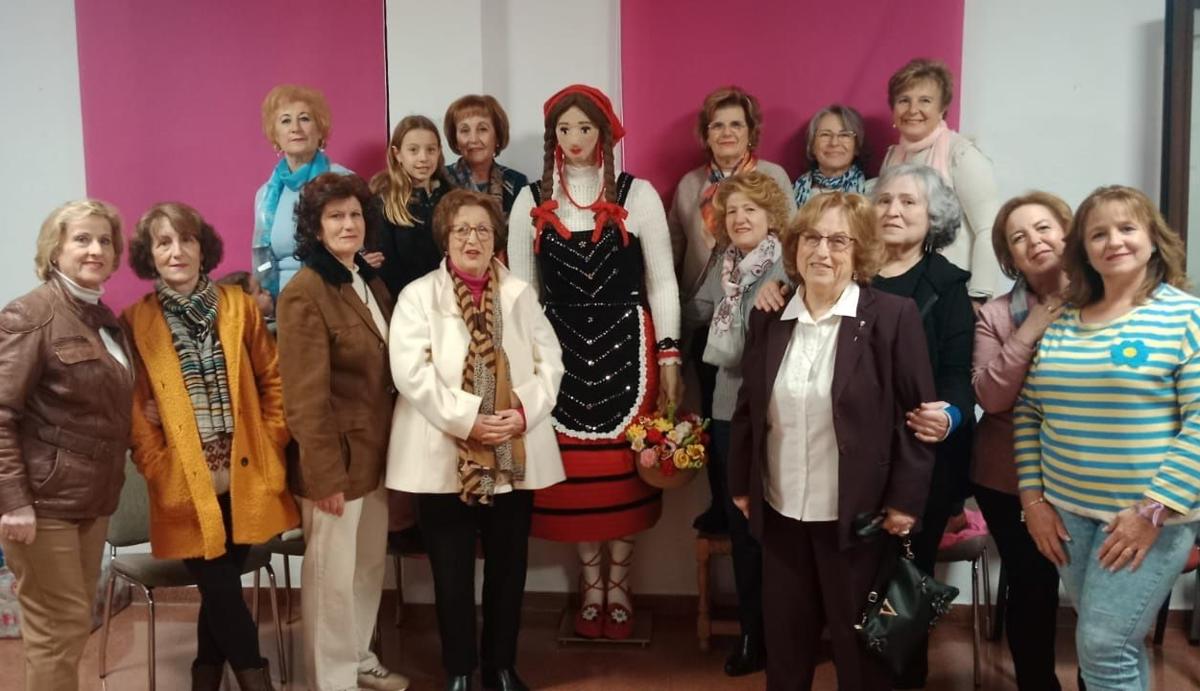 Mujeres de Campillo de Arenas posan junto a la figura de aldeana que han confeccionado este año.