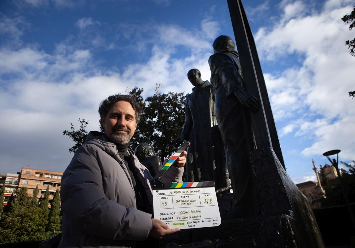 Óscar Parada con la claqueta de 'El menor de los hermanos' ante el monumento a San Juan de Dios en los Jardines del Triunfo.