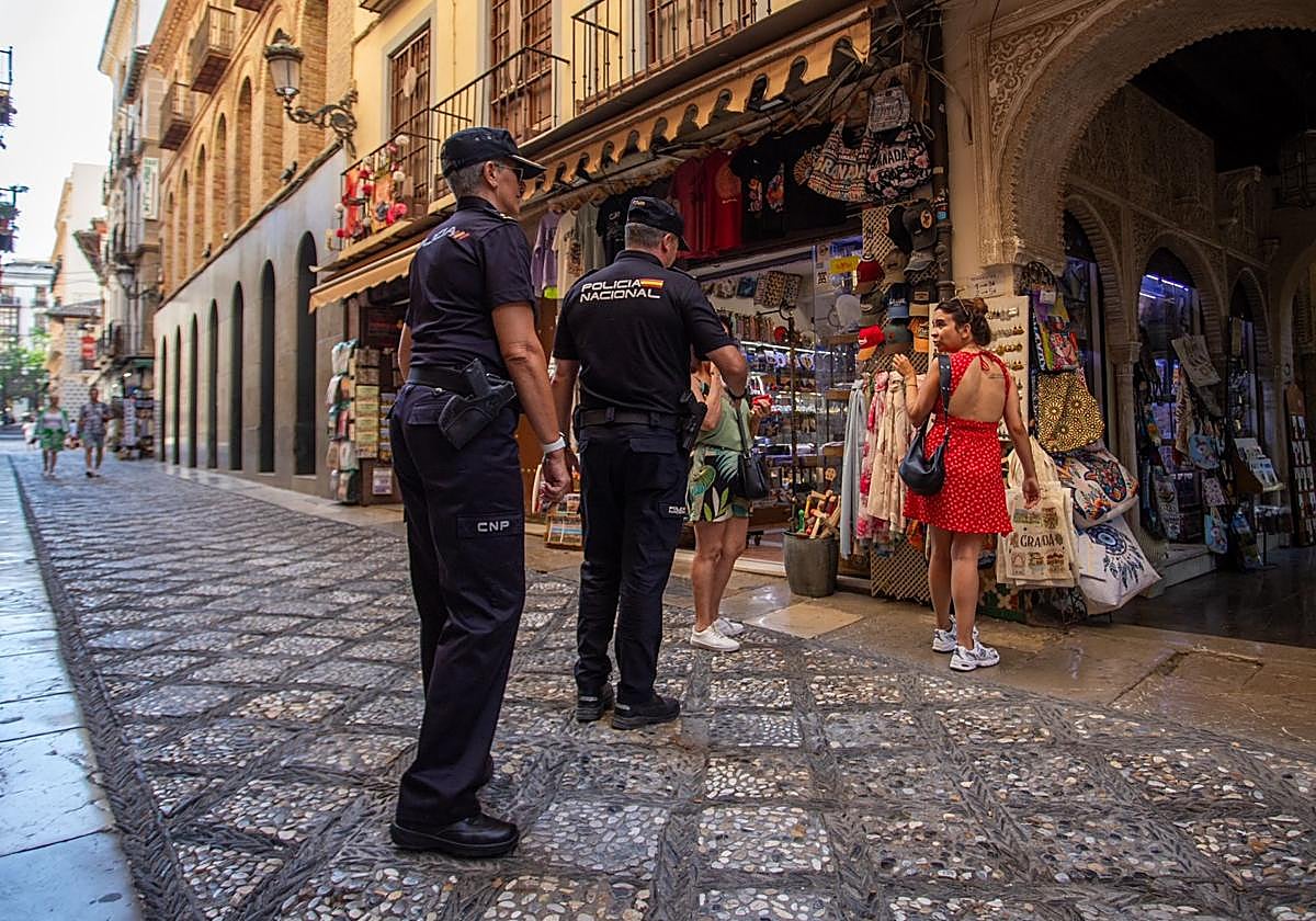 La Policía Nacional le advierte a dos turistas portuguesas de que tengan cuidado con sus bolsos.