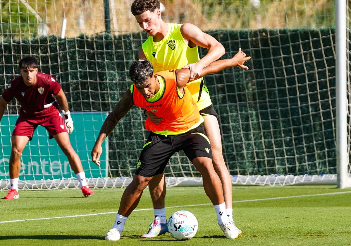 Marcos Peña protegiendo el balón ante Dzodic en un entrenamiento.