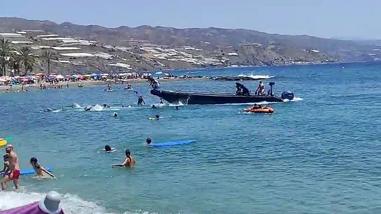 Desembarco de inmigrantes a plena luz del día en la playa de Castell de Ferro llena de bañistas