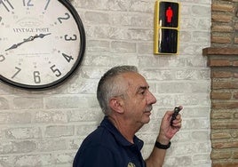 José Luis, propietario del Mesón Baena, junto al semáforo que ha instalado en su negocio.