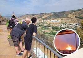 Decenas de curiosos se acercan para observar el panorama desolador de toda la vegetación de la ladera completamente chamuscada (en pequeño, las llamas cerca del restaurante Balcón del Genil).