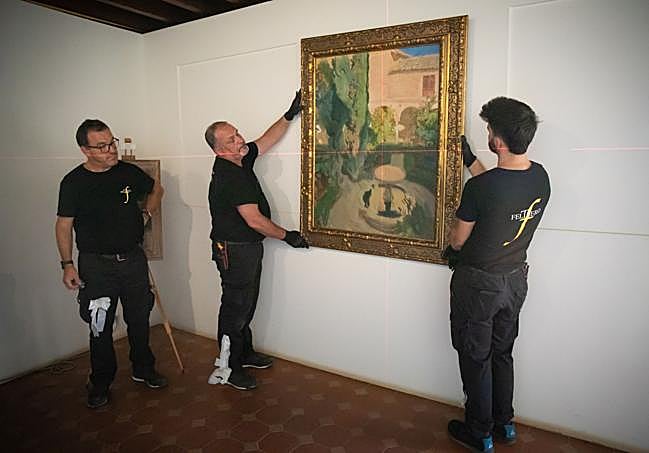 Colocando el cuadro de Sorolla en la pared.
