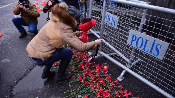 Una mujer homenajea con flores a las víctimas de Estambul. 