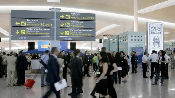 Viajeros en las instalaciones del aeropuerto de El Prat (Barcelona).