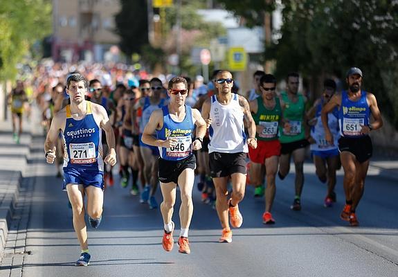Salida de la calle del Río Genil, en Ogíjares, con el fondista del Club Olimpo Chema Fernández destacándose en el grupo de cabeza.