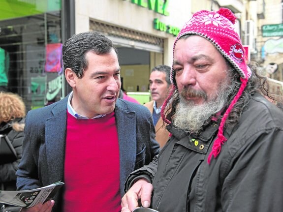 Moreno explica su propuesta sobre las herencias a un músico callejero, ayer en Jaén.