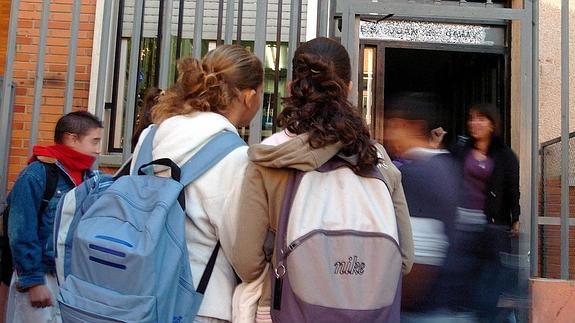 Dos niñas, en las puertas de su centro escolar. 