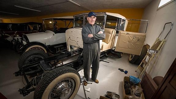 Aravaca, embutido en su mono de trabajo y su gorra, junto al Cadillac que ya está terminando de restaurar. 