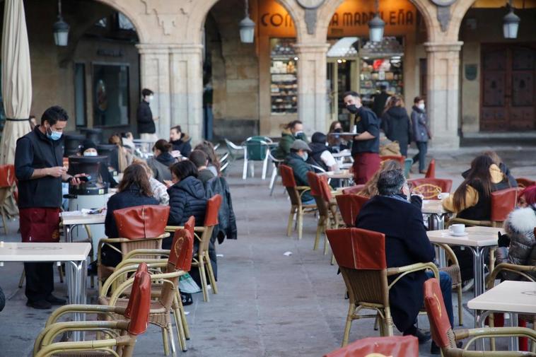 Camareros y clientes en una terraza en la Plaza Mayor.