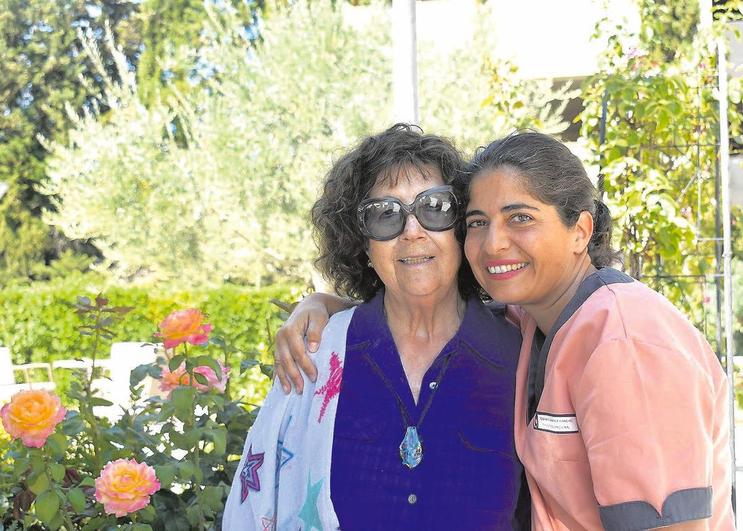 Una residente de Ballesol Salamanca disfruta junto a una trabajadora en el jardín