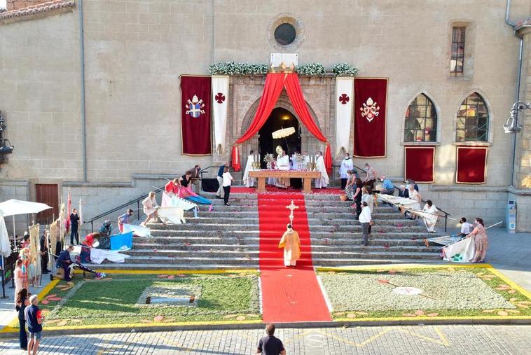 Dos alfombras decoraron las escaleras de acceso a la iglesia de El Salvador para acoger a las banderas y estandartes que se rindieron ante el Santísimo Sacramento.