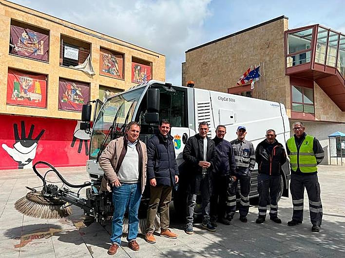 Responsables municipales y trabajadores junto a la barredora.