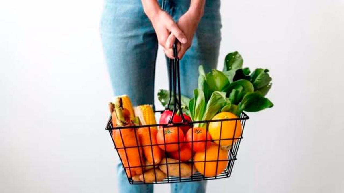 Una cesta con frutas y verduras.