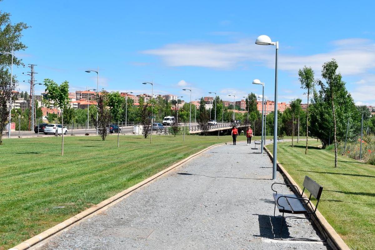 Dos mujeres paseando por la zona de senderos más cercana al puente Juan Carlos I en La Serna