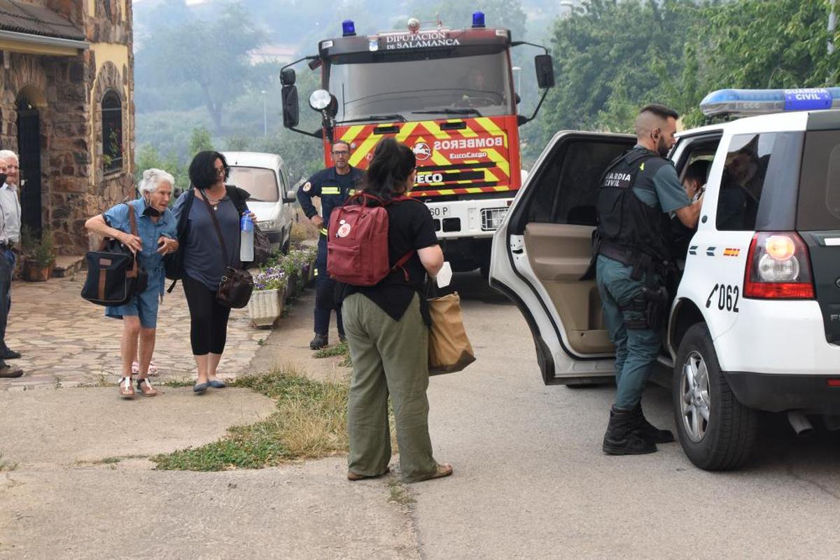 Ana Rubio, con una botella en la mano, ayuda a su suegra a salir de casa.