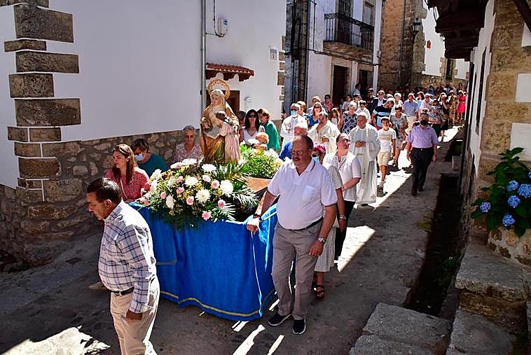 La imagen de Santa Ana lució en su trono engalanado con flores en el recorrido arropada también por los fieles de Candelario.