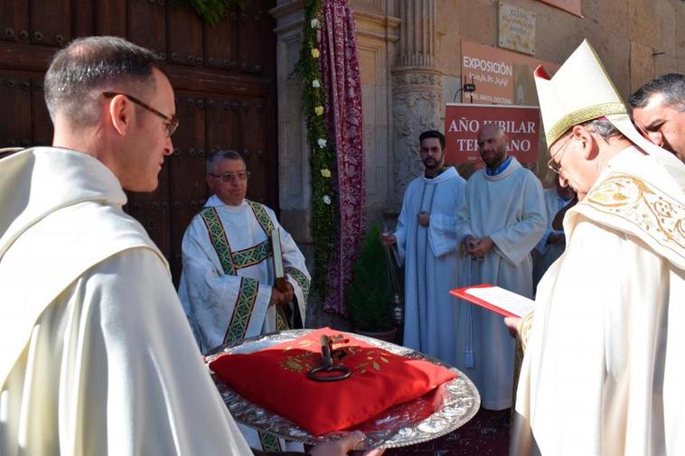 El prior, Miguel Ángel Sánchez, sostiene la llave de la Puerta Santa ante el obispo emérito Carlos López