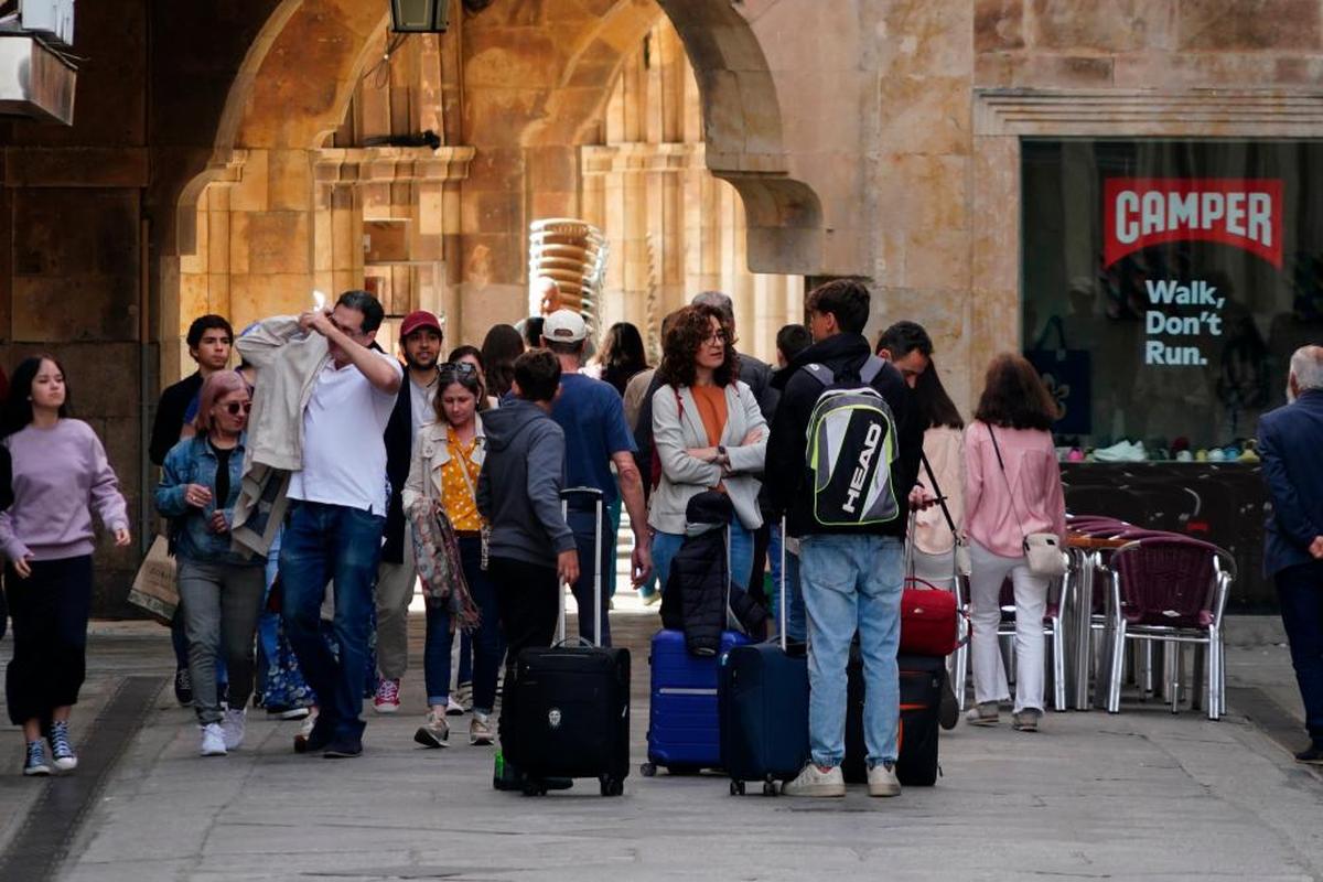 Una familia, con maletas, abandonando ayer su alojamiento turístico