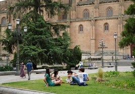 Gente en el césped junto a la Catedral de Salamanca