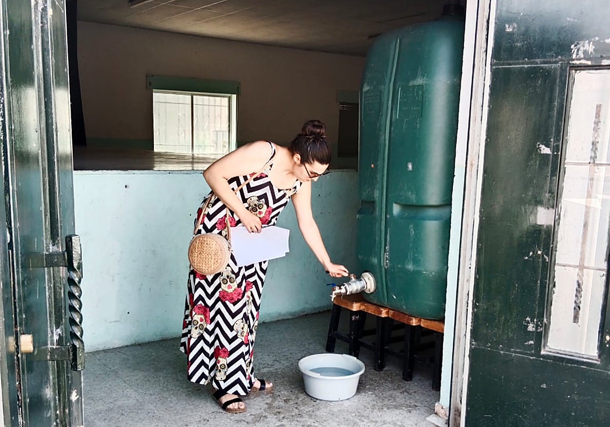 Una vecina de Encinas de Abajo junto al depósito colocado por la Diputación para suministrar agua potable.