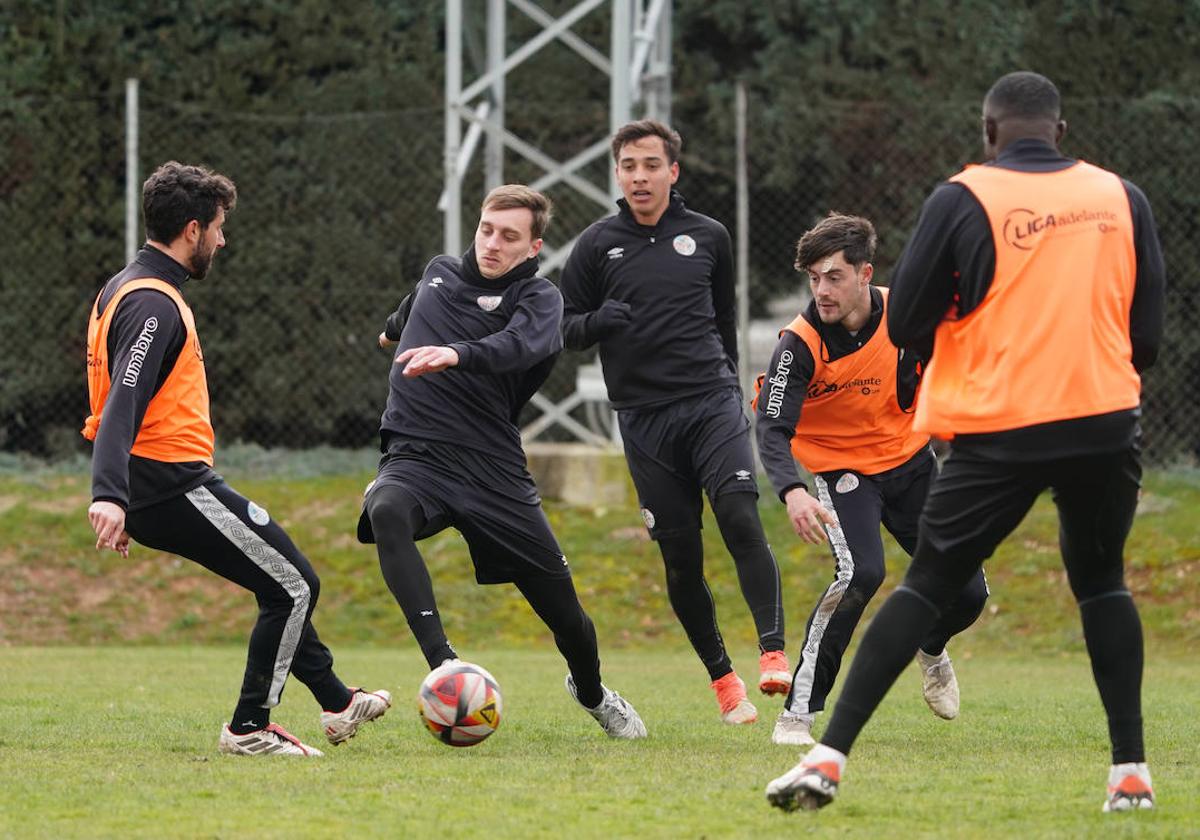 Fassani trata de hacerse con un balón que toca Diego Benito en un rondo.